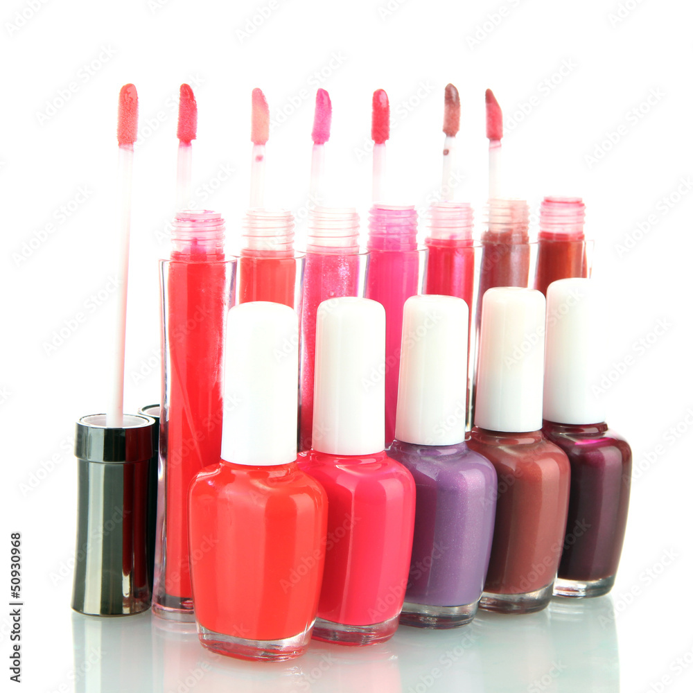 beautiful lip glosses and nail polish bottles, isolated on
