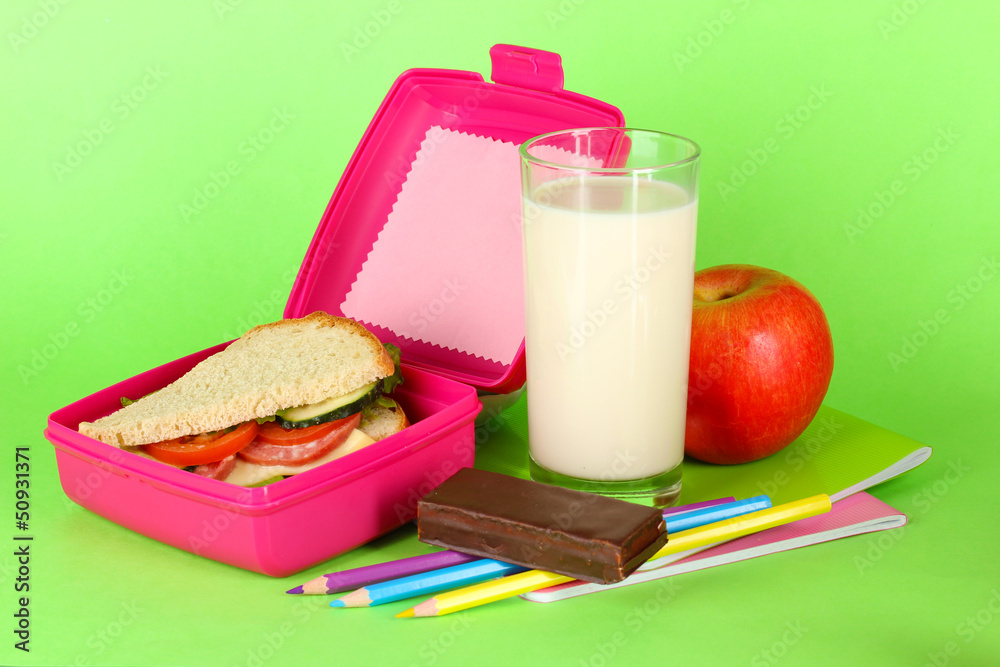 Lunch box with sandwich,apple,milk and stationery