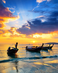 Wall Mural - Traditional thai boats at sunset beach