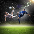© Sergey Nivens - two football players striking the ball
