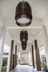 Walk way with the tile roof and lamp within the resort