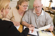 © Andy Dean - Senior Adult Couple Going Over Papers in Their Home with Agent