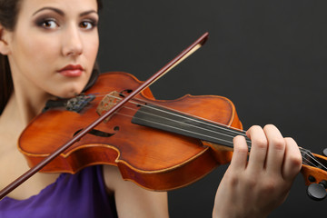 Canvas Print - Beautiful young girl with violin on grey background