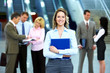 © grinny - Business woman and a group of workers.