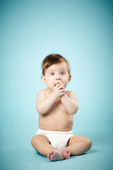 Wall Mural - cute happy baby on blue background