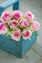 Wall Mural - roses in an old blue wooden gardening basket