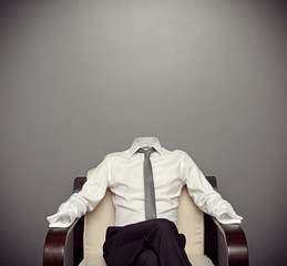 invisible man sitting on armchair