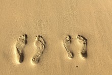 Two Pairs Footstep On The Beach