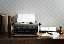 Old Typewriter On A Wooden Desk