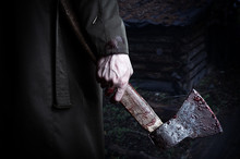 Axe With Blood In Male Hand