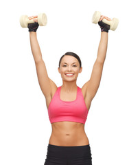 Wall Mural - young sporty woman with light dumbbells