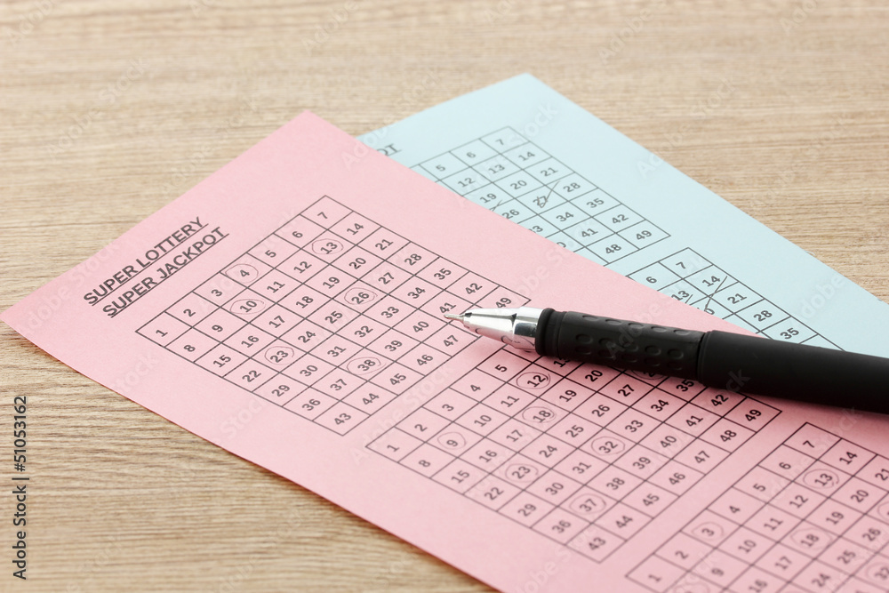 Lottery tickets and pen, on wooden background