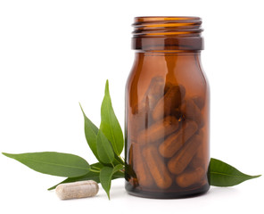 Wall Mural - Herbal drug capsules in brown glass bottle. Alternative medicine