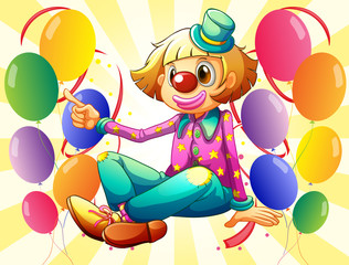 Wall Mural - A female clown sitting in the middle of the balloons