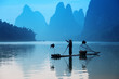 © konstantant - Chinese man fishing with cormorants birds, Yangshuo, Guangxi reg