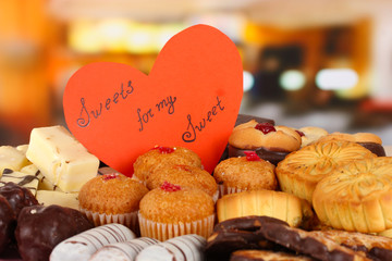 Wall Mural - Sweet cookies with valentine card on table in cafe