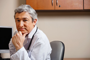 Serious Doctor With Hand On Chin