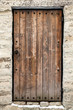 Ancient wooden door in old stone castle wall. Tallinn, Estonia