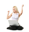 © lenets_tan - A young woman sitting on the floor with a laptop