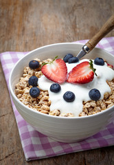 Wall Mural - Bowl of healthy muesli with yogurt and fresh berries