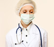 © lenets_tan - A female doctor wearing a mask, isolated on white background