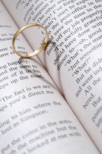 Wedding Ring Casts Heart-shaped Shadow On The Book Page
