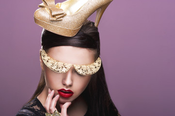 Sexy woman woth gold shoe on head