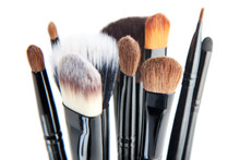 Makeup brushes on a white background