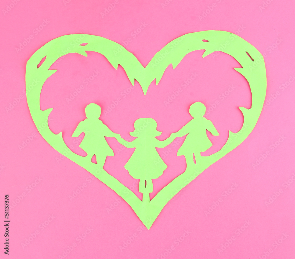 Green cut out paper heart with people inside,