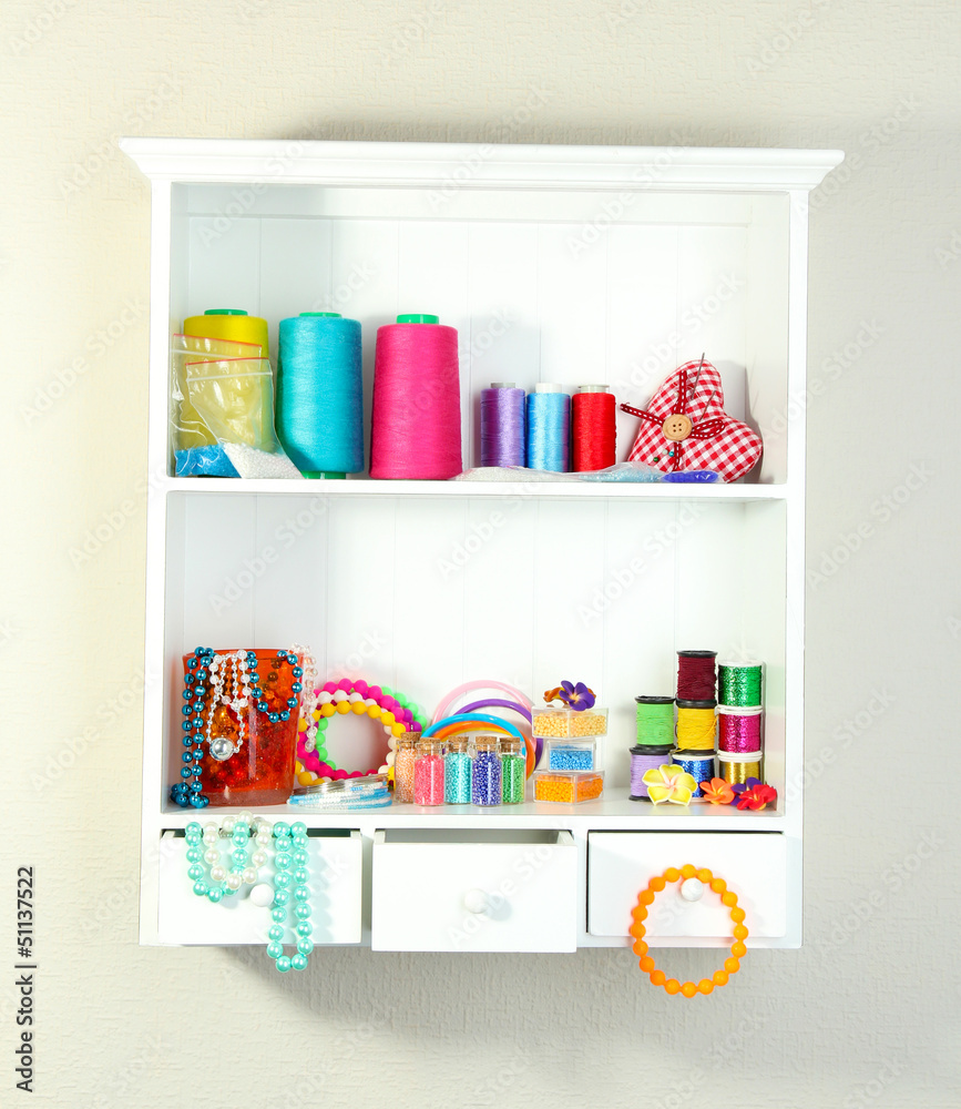 Beautiful white shelves with thread and material for