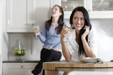 Two friends relaxing in the kitchen