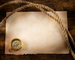 Fototapete - old compass and rope on vintage paper