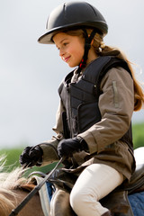 Wall Mural - Horse riding - lovely girl is riding on a horse