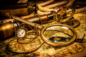 vintage magnifying glass lies on an ancient world map