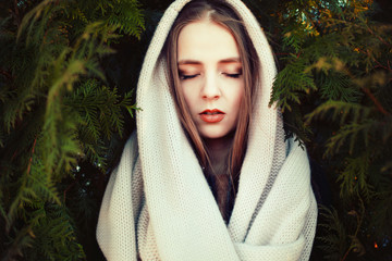 Outdoor portrait of young sensual woman with closed eyes