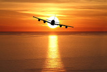 Beautiful Sunset With Airplane Over The Sea