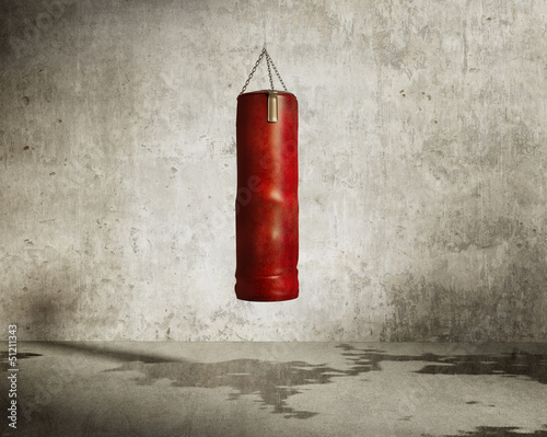 Naklejka na drzwi Grungy martial arts training room, red boxing bag