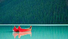 Canoes Floating Peacufully On Lake Louise Near Banff.