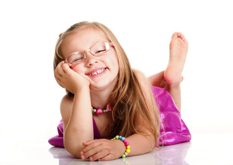 Wall Mural - cheerful little girl glasses funny is lying isolated