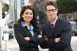 © Monkey Business - Portrait Of Businessman And Businesswoman Outside Office