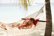 © Monkey Business - Romantic Couple Relaxing In Beach Hammock