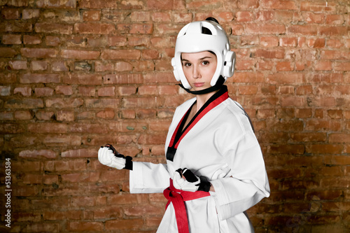 Foto Woman in sportswear and brick wall