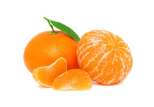 Two Ripe Mandarins And Two Slices With Green Leaves (isolated)