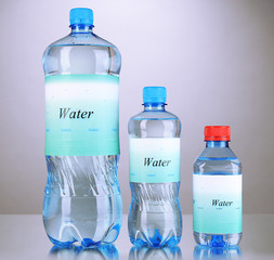 Wall Mural - Different water bottles with label on grey background