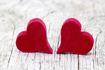 two red hearts on wooden background