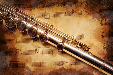 Wall Mural - silver flute on an ancient musical background