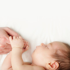 Baby and father's hands on white background