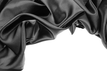 Black silk fabric material on white. Copy space