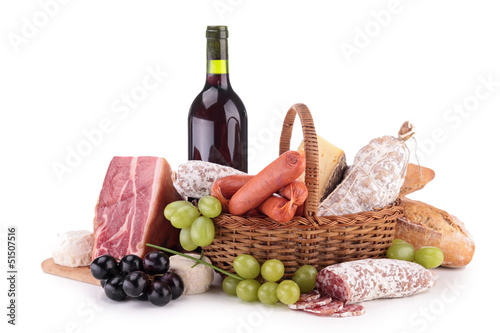 Fotografie, Obraz wicker basket with sausages, ham and wine