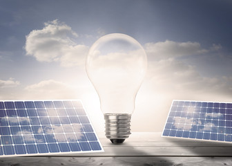 Poster - Light bulb and solar panels on floorboards in the sky